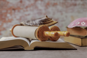 A Torah lying on top of an open prayer book