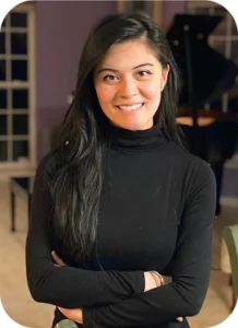 Smiling young woman with long dark hair with a black turtleneck