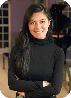 Smiling young woman with long dark hair with a black turtleneck