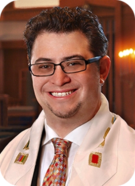 Smiling male rabbi with glasses and short dark hair