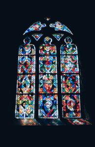 Non-denominational stained glass window with sunlight coming in